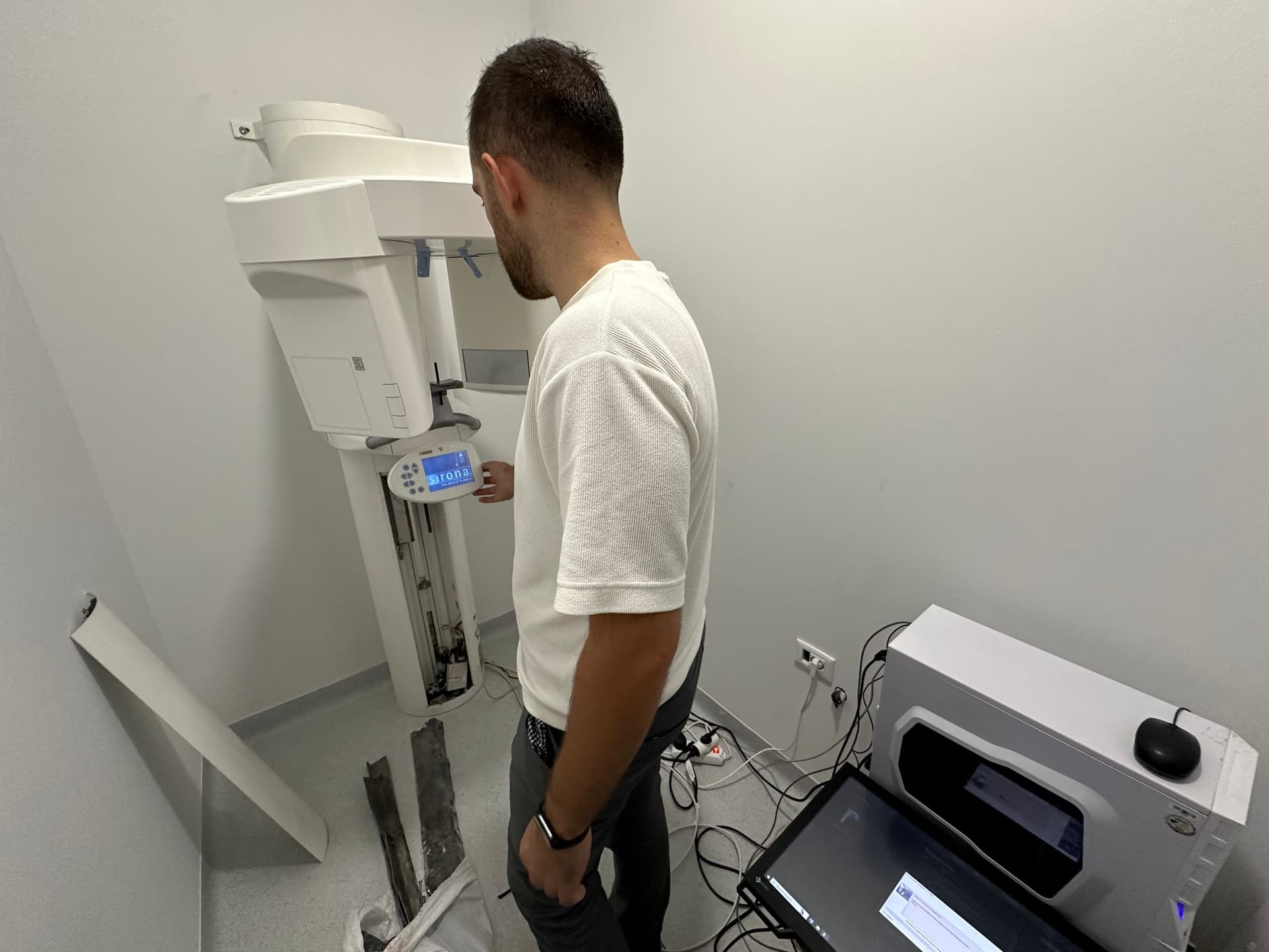Erion Çollaku testing a panoramic X-ray unit at its control panel